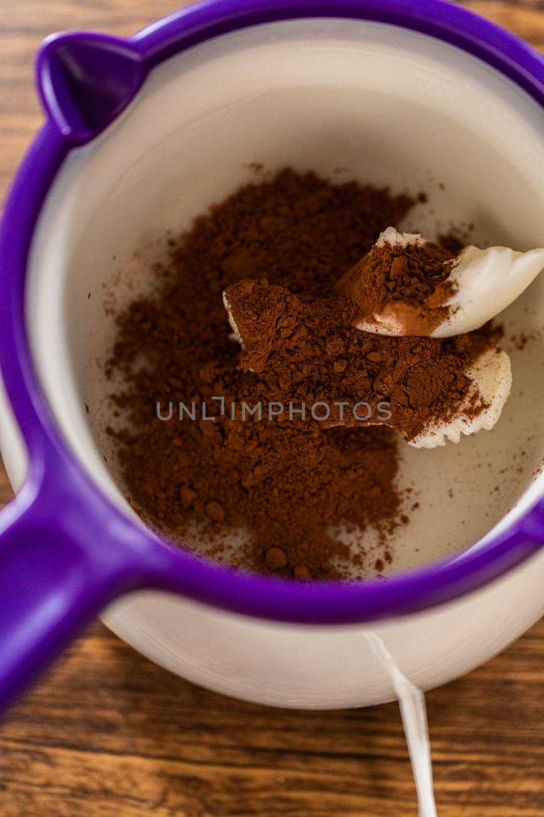 Carefully greasing a bundt cake pan in preparation for baking a delicious gingerbread bundt cake with caramel frosting.