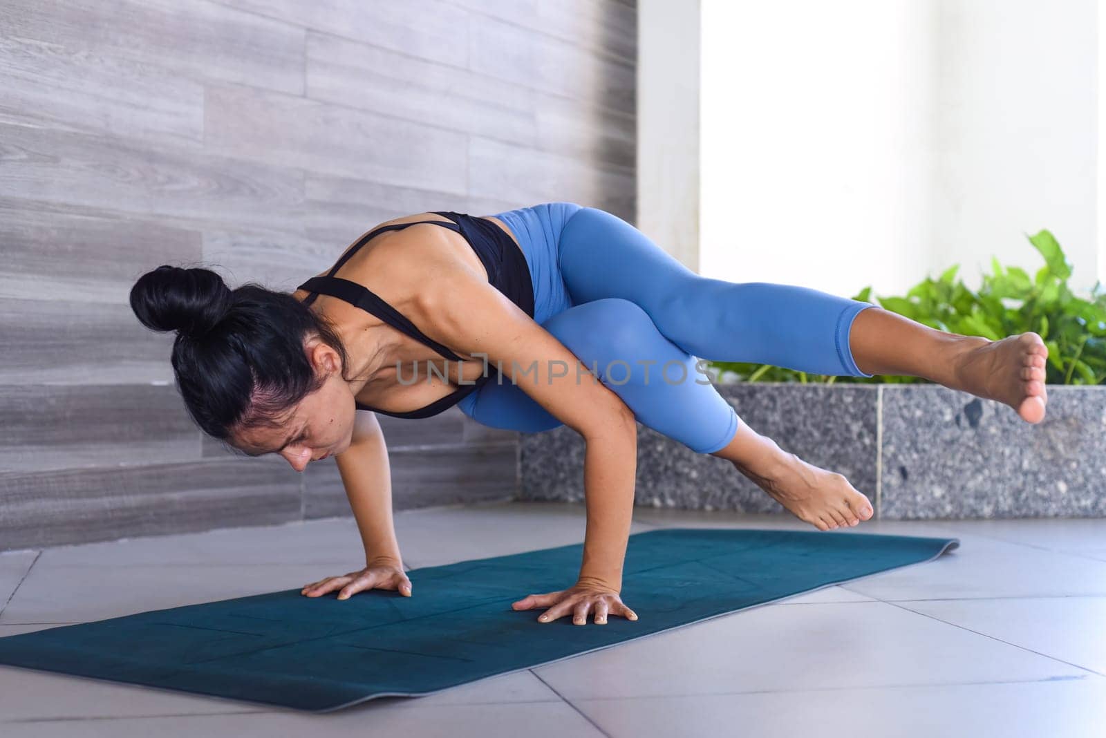 side crow pose variation 
parsva bacasana yoga with ukrainian woman making it indoors