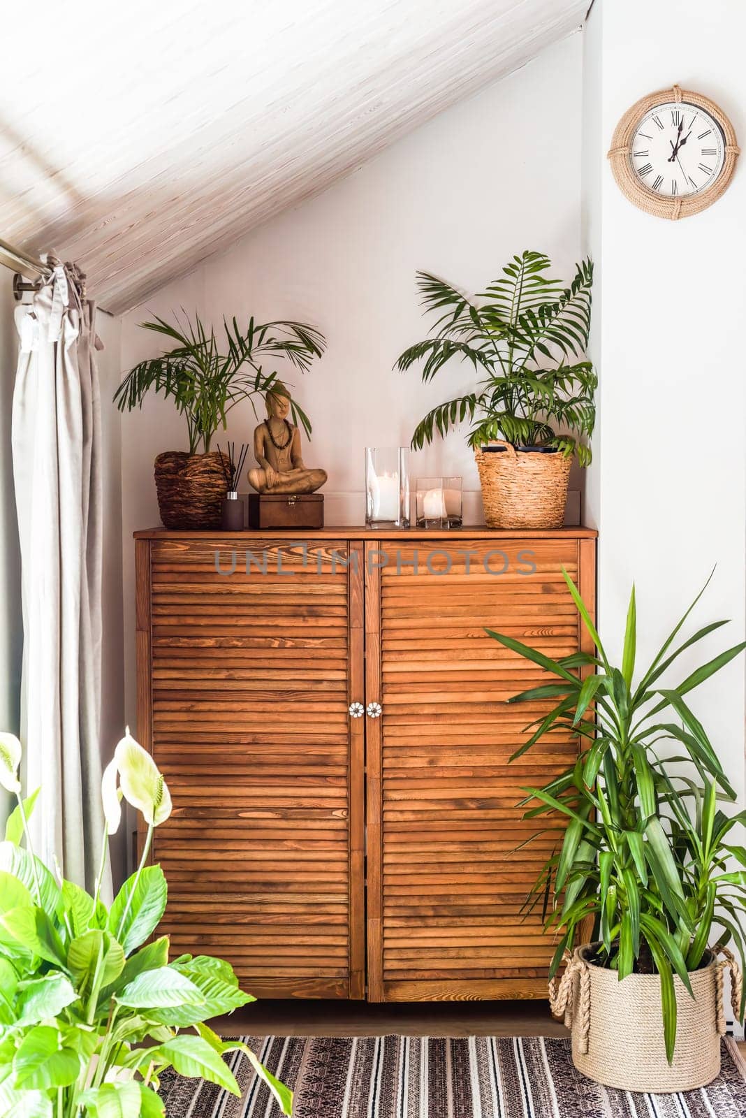 wooden chest of drawers with decorations and flowers in the interior