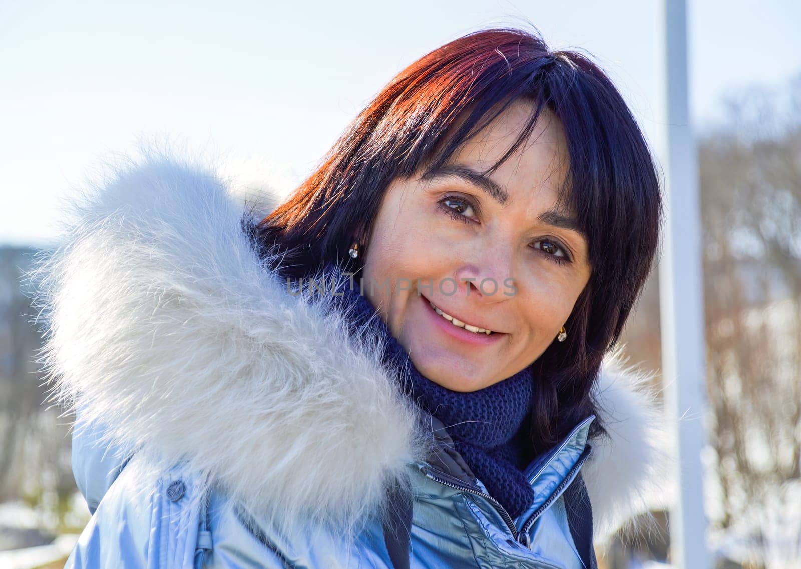 Forty five year old Russian woman sincerely, naturally and kindly smiling, looking at the camera