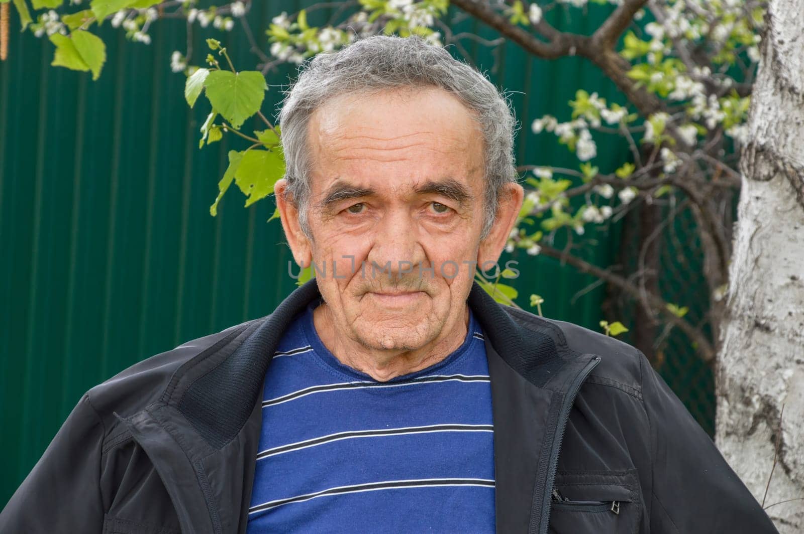 Portrait of Russian 70 years old man looking at camera