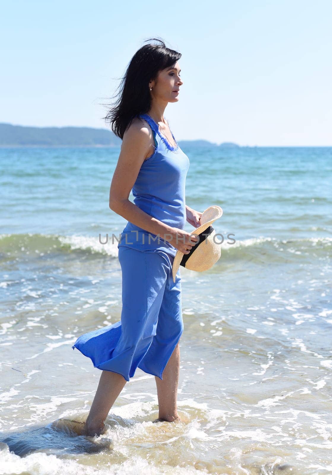 45 years old Russian woman  standing in Japanese sea and looking away