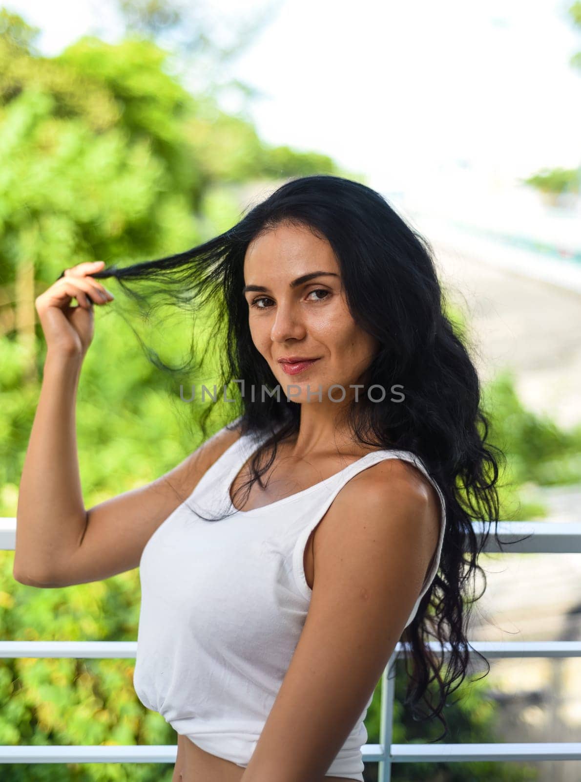 Portrait of sexy ukrainian woman touching her hair and looking down