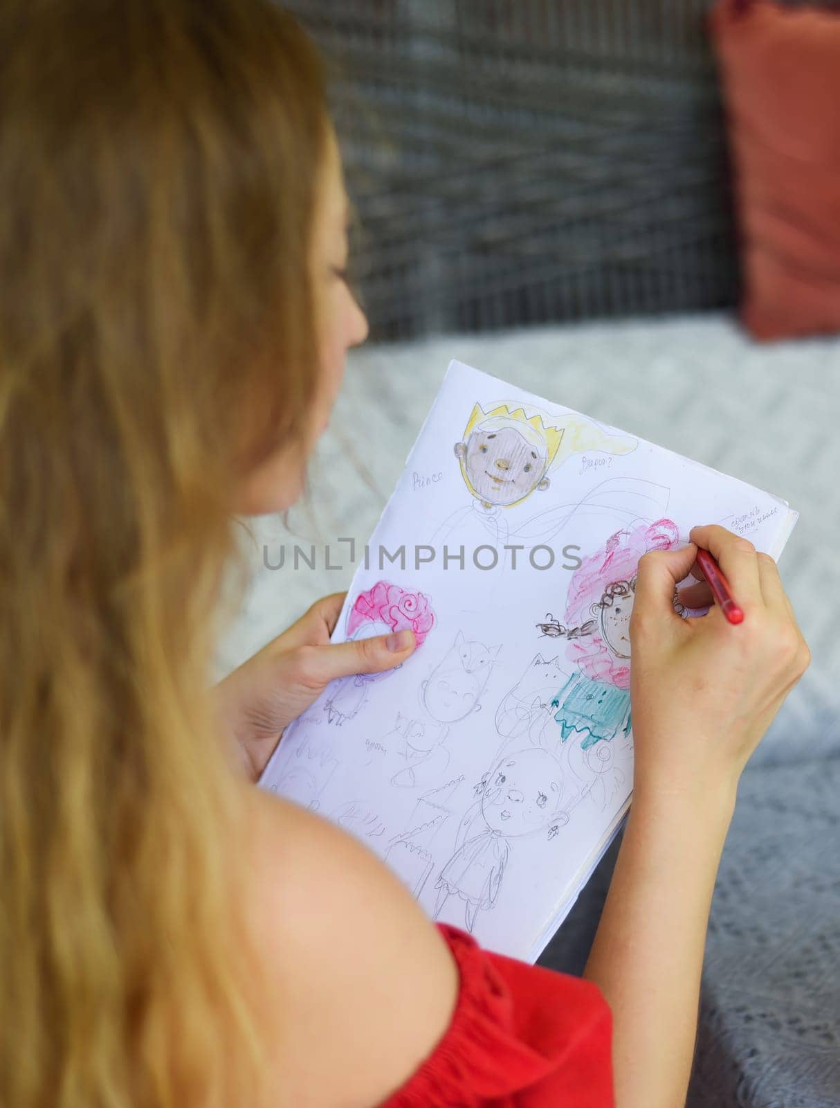 Blonde woman artist and illustrator drawing sketches by pencil