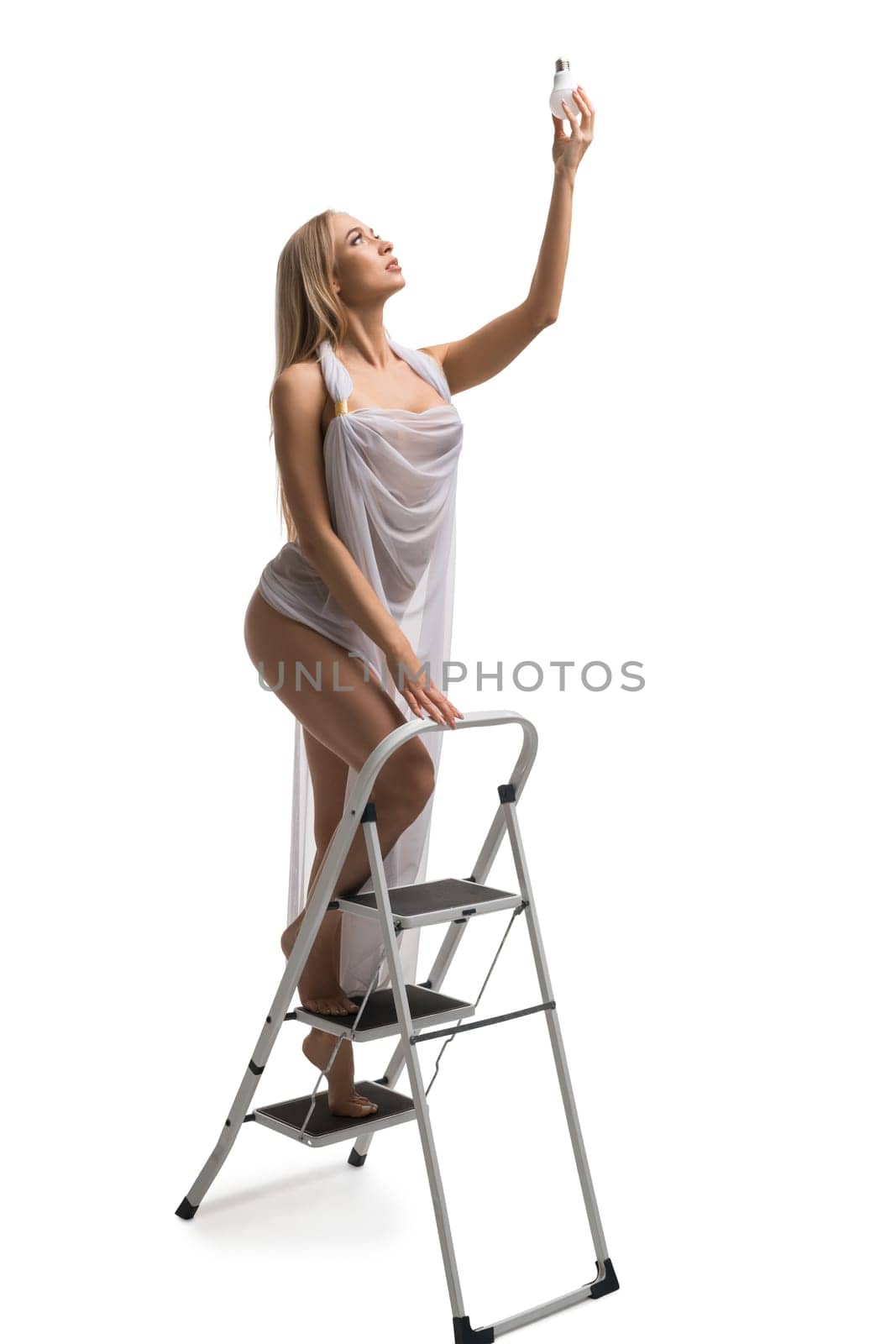 Pretty girl in white on a ladder full-length isolated shot