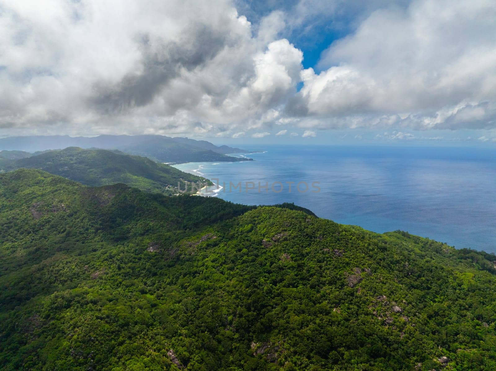 Aerial view of Coast of Mahe island with rainforest and blue ocean. Seychelles.