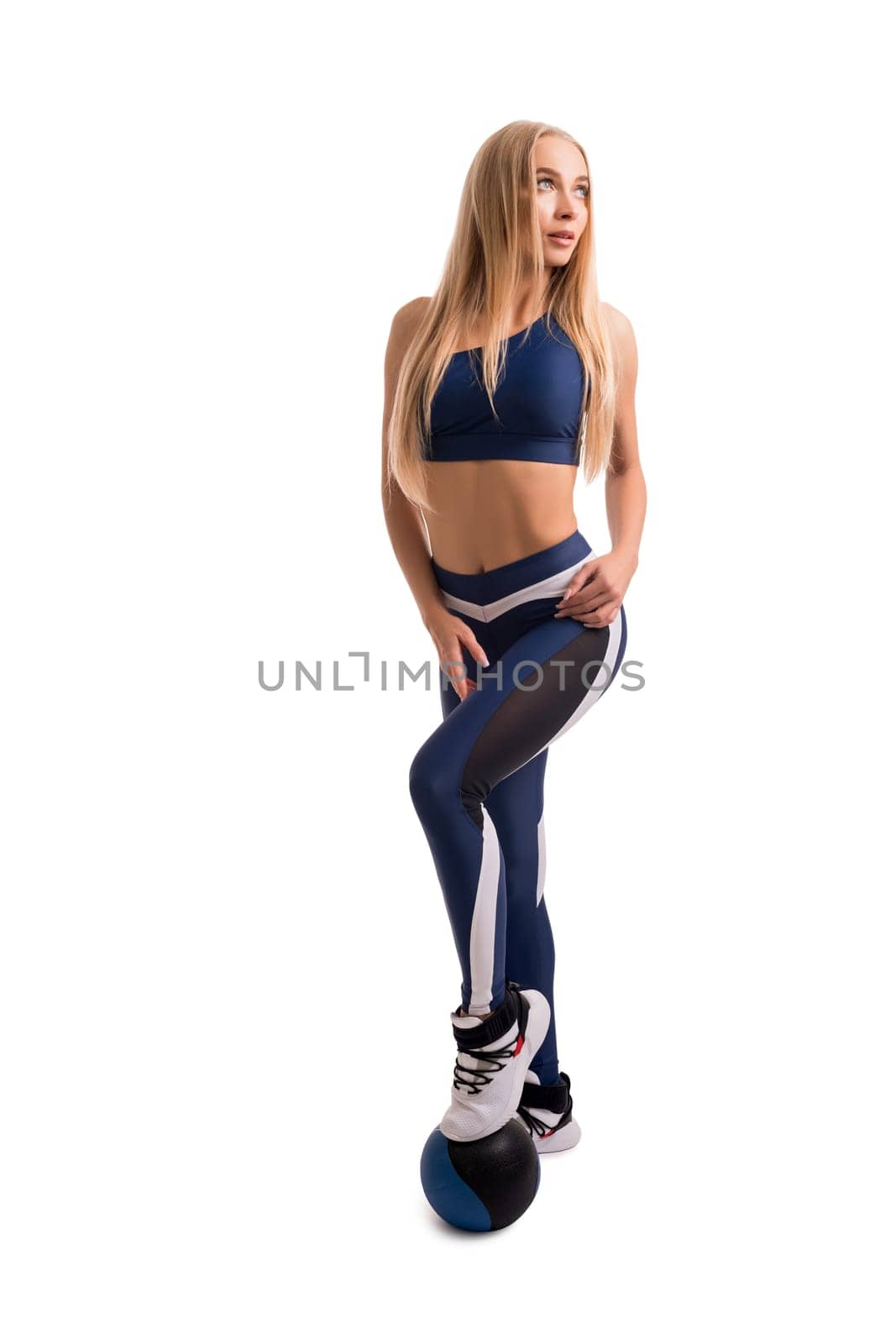 Pretty blonde fitness model with a ball isolated full-length shot