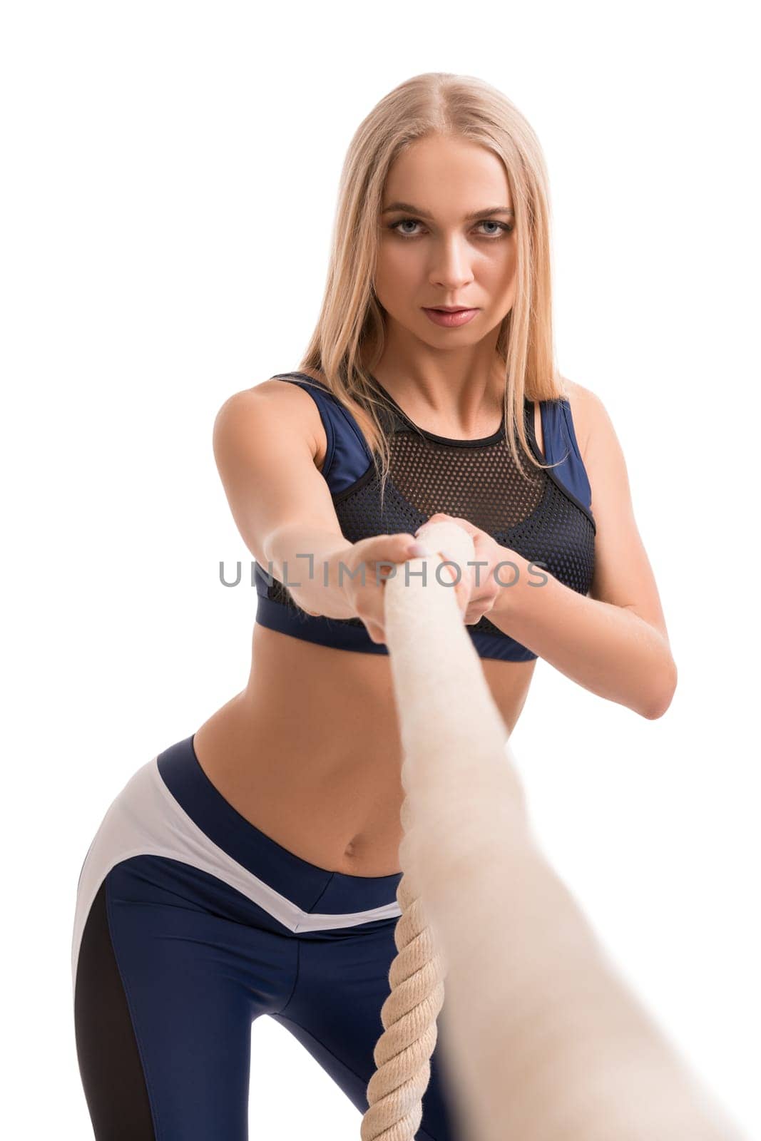 Beautiful blonde fitness model exercising with a rope isolated cropped shot