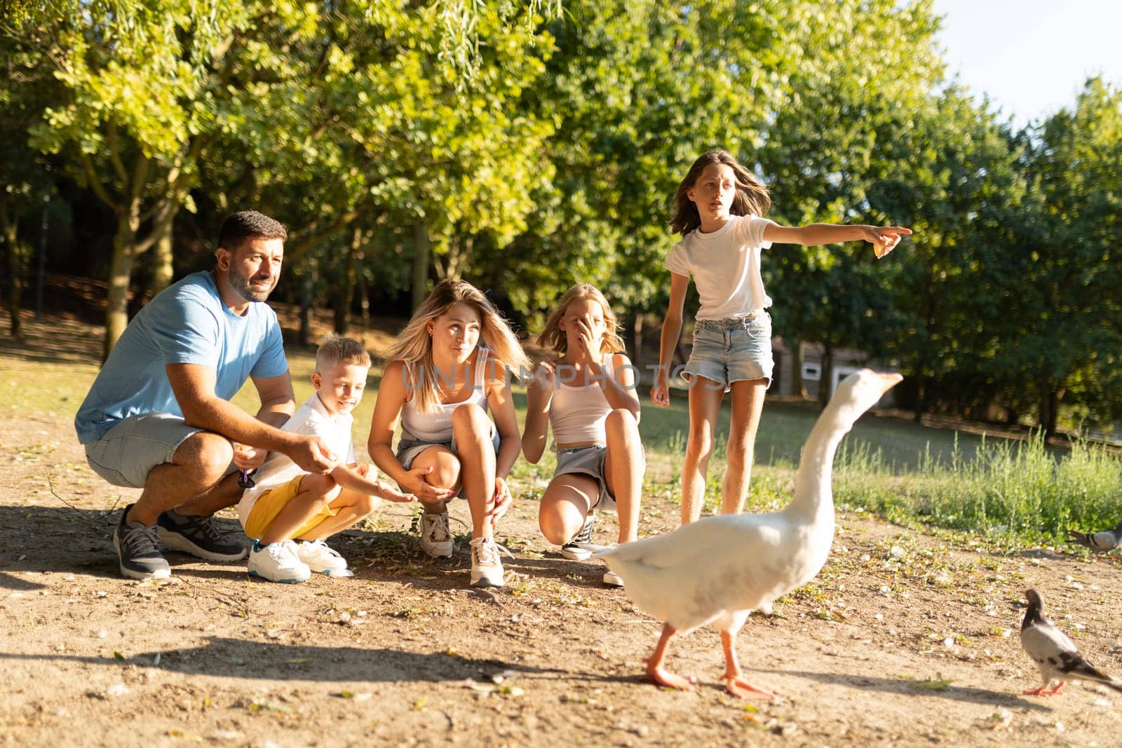 Family spending time outdoors watching ducks and enjoying nature