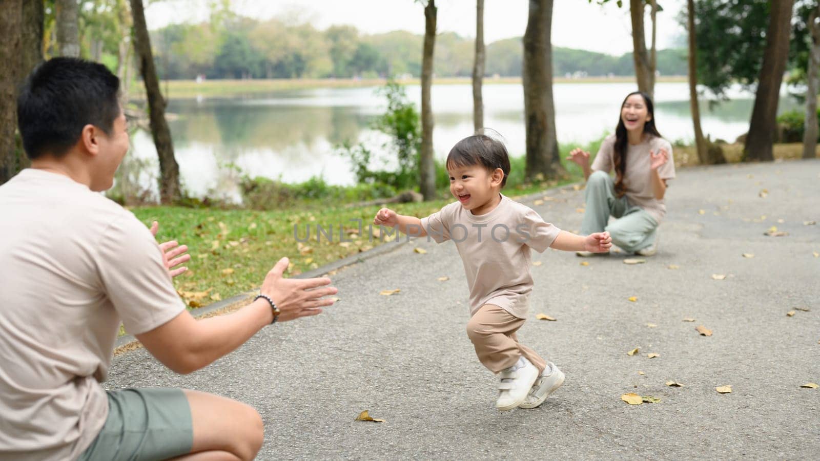 Adorable happy little boy running towards father with joyful expressions.