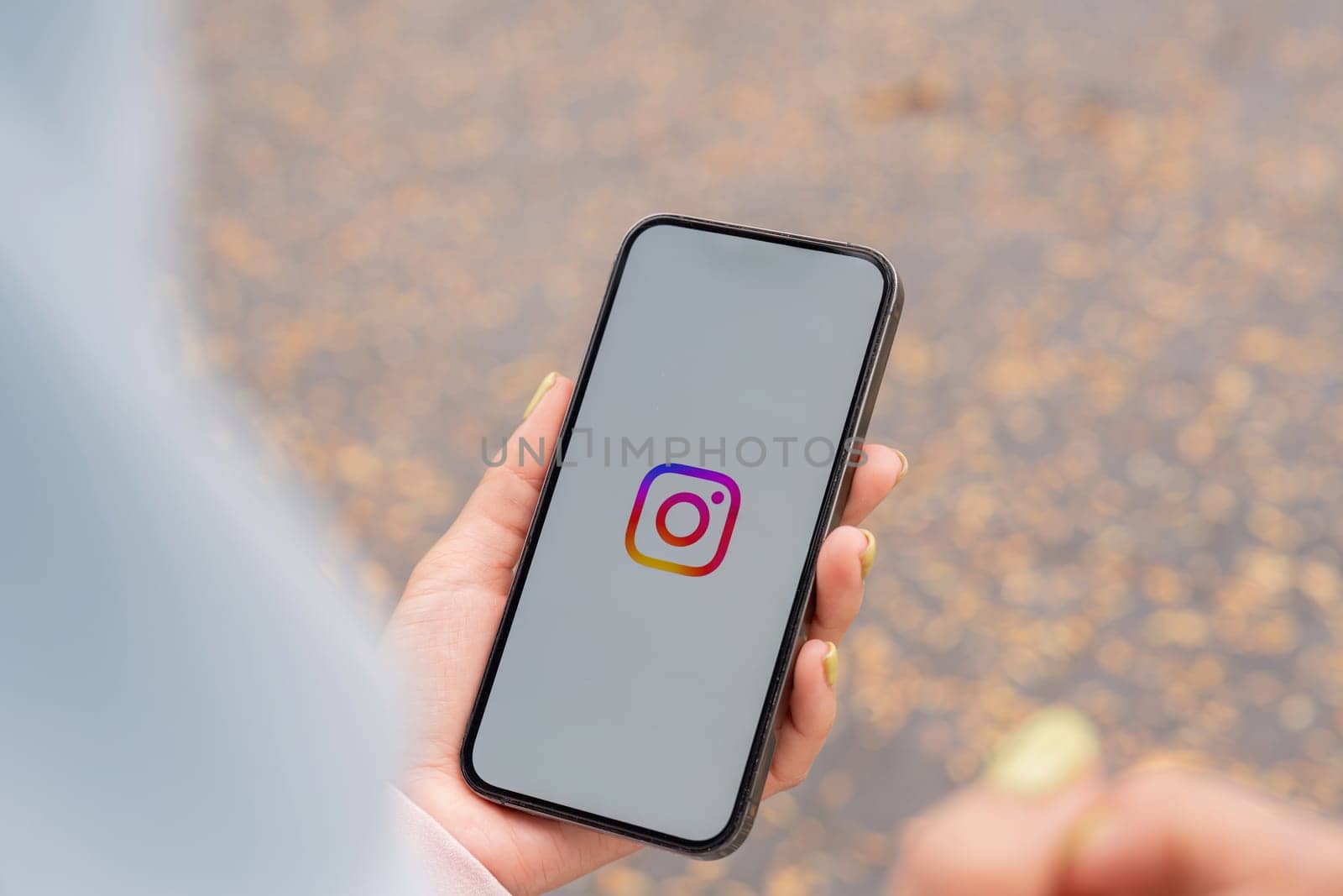 CHIANG MAI, THAILAND - January 27,2025 : A woman holds Apple iPhone with Instagram application on the screen. Instagram is a photo sharing app for smartphones.