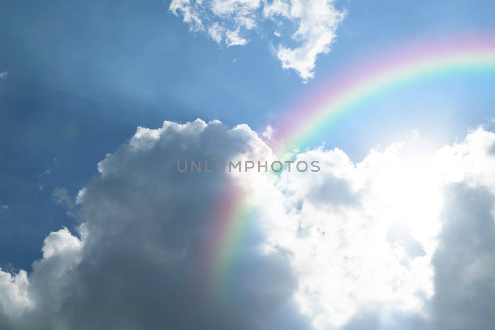 Nature cloudscape with blue sky and white cloud with rainbow