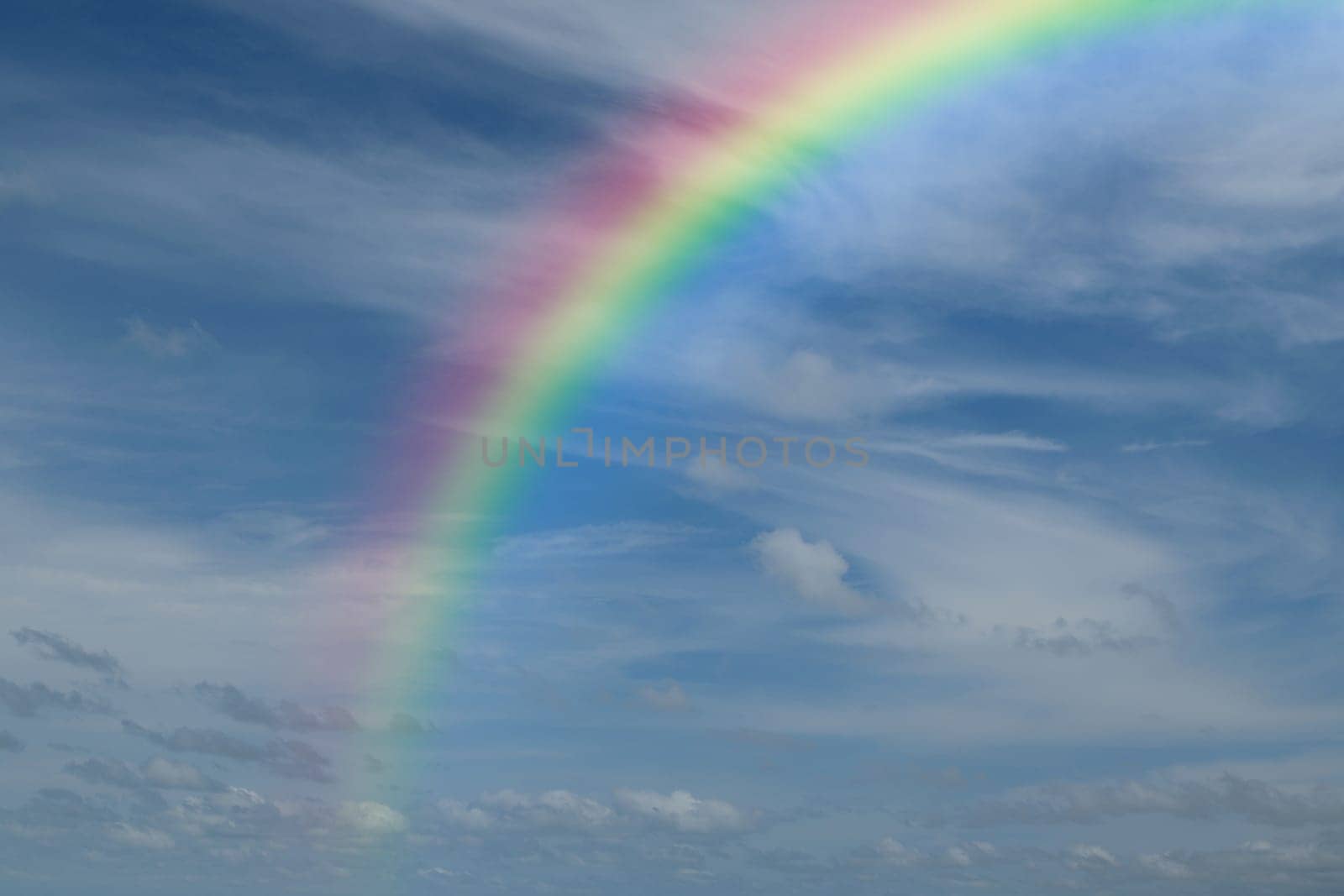 Nature cloudscape with blue sky and white cloud with rainbow