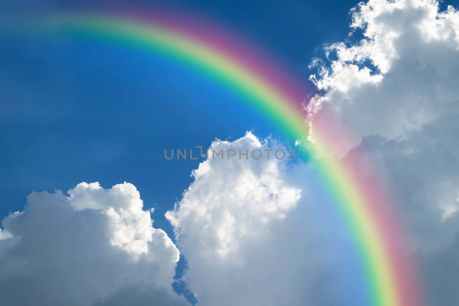 Cloudscape rainbow of natural sky with blue sky and white clouds and colorful rainbow in the sky use for wallpaper background