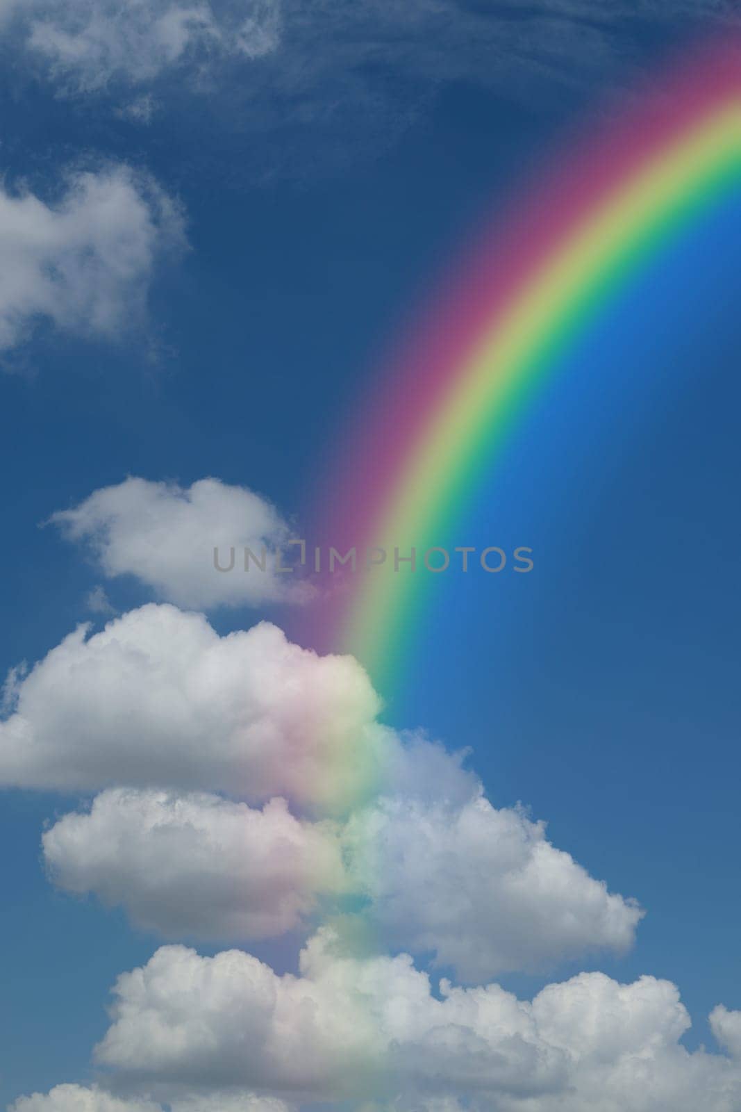Nature cloudscape with blue sky and white cloud with rainbow