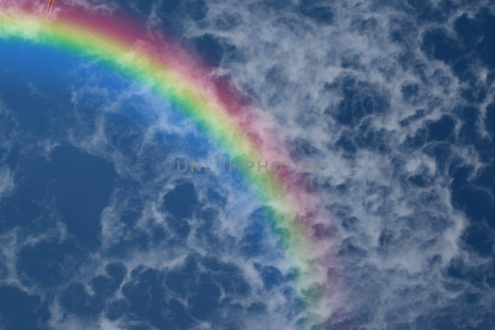 Nature cloudscape with blue sky and white cloud with rainbow