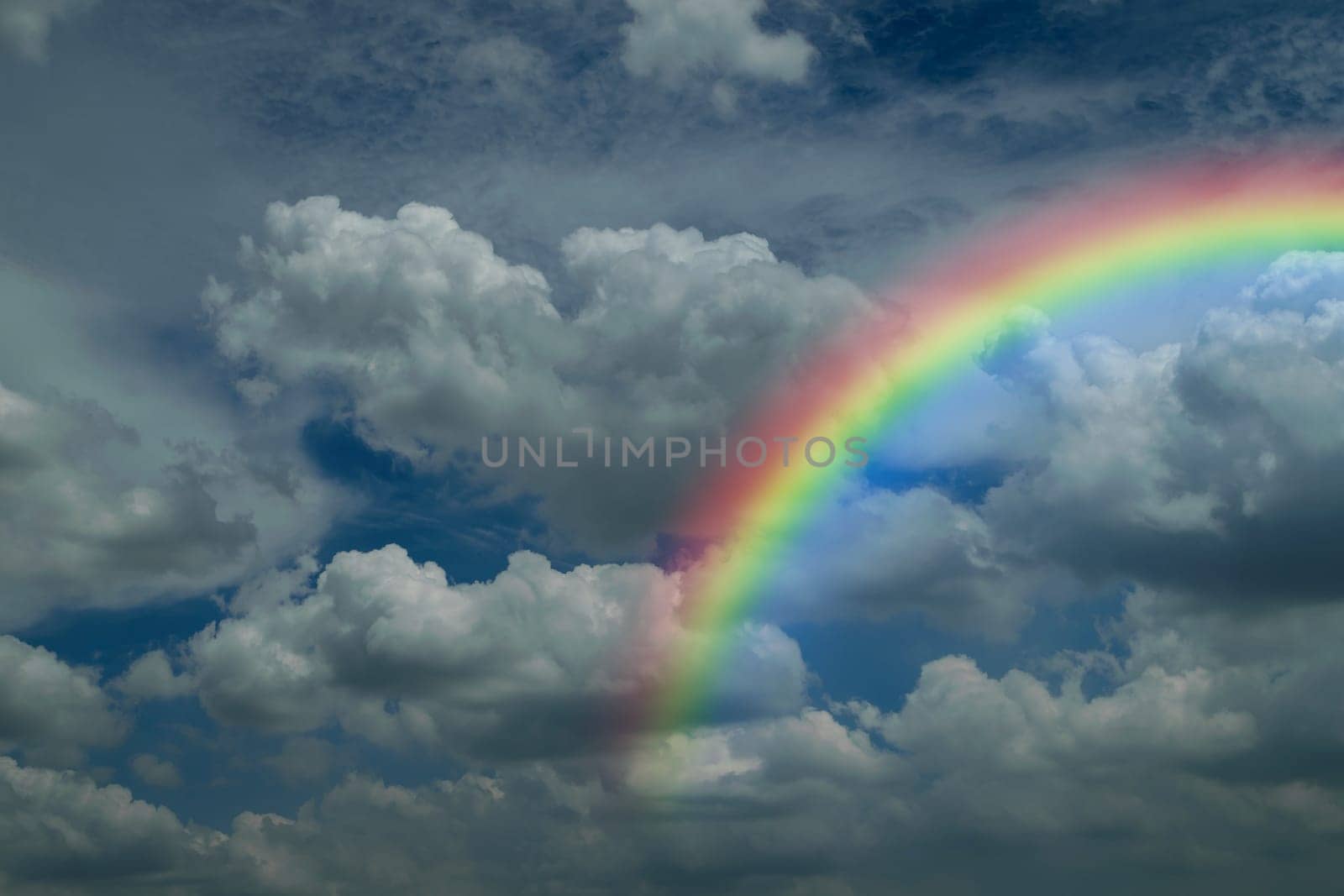Nature cloudscape with blue sky and white cloud with rainbow