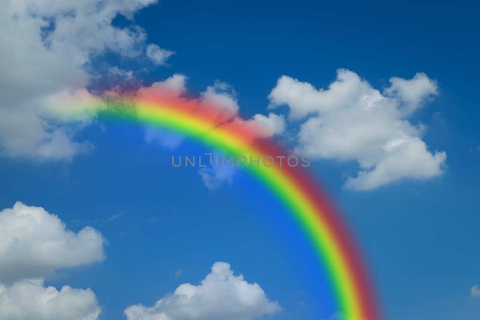 Nature cloudscape with blue sky and white cloud with rainbow