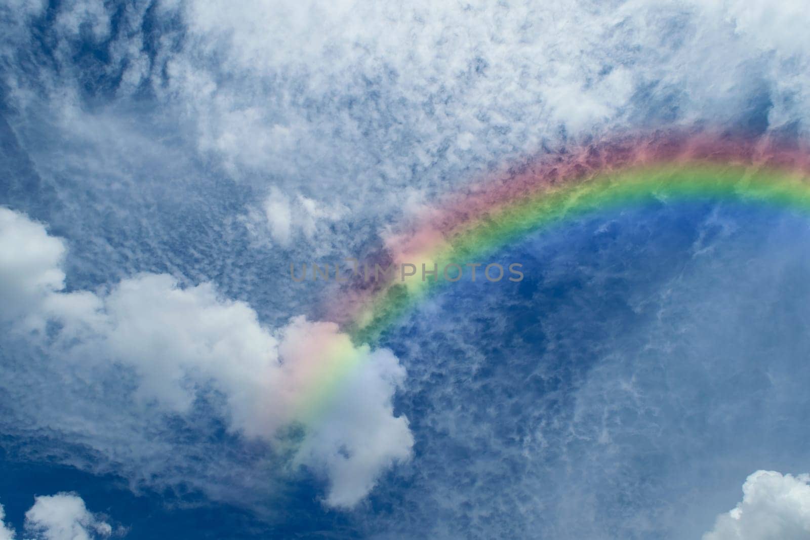 Nature cloudscape with blue sky and white cloud with rainbow