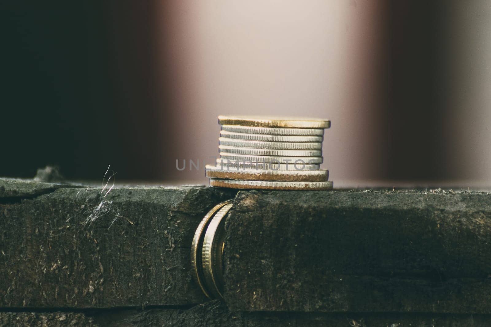 Thai coin stacked on a wood table , process in vintage style