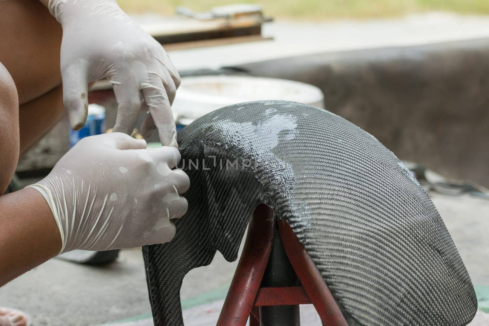 Wrapping carbon fiber or kevlar and man hand for working