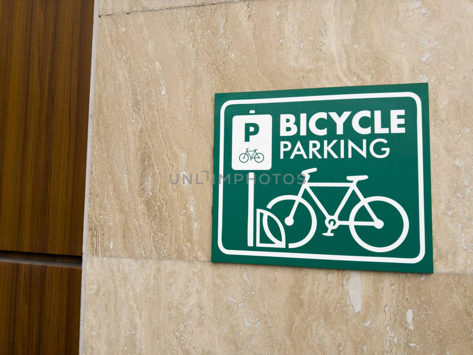 Bicycle parking. Information sign on wall designating area for safe parking of bicycle on street using special lock and wheel mount. Bicycle parking station sign on wall