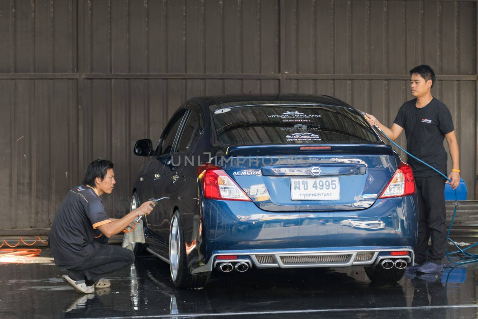 Bangkok, Thailand - December 12, 2015 : Unidentified car care staff cleaning the car.