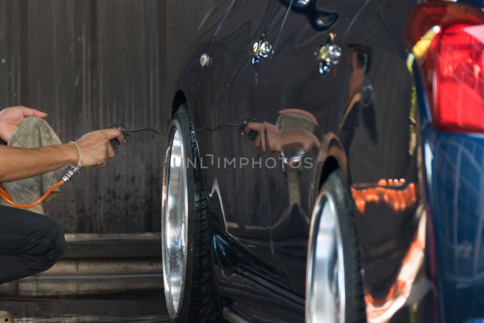 Bangkok, Thailand - December 12, 2015 : Unidentified car care staff cleaning the car.