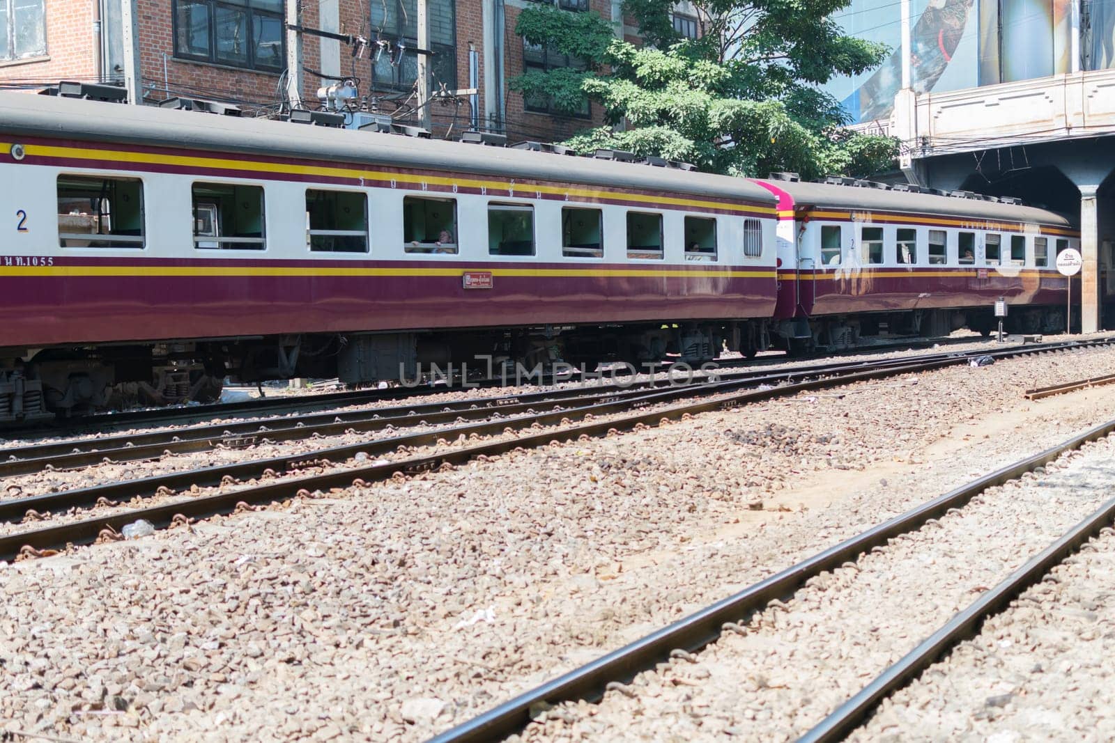 Bangkok, Thailand - December 30, 2015 : Unidentified railway train run on the railroad tracks. Many people in Thailand popular travel by train because it is cheaper.