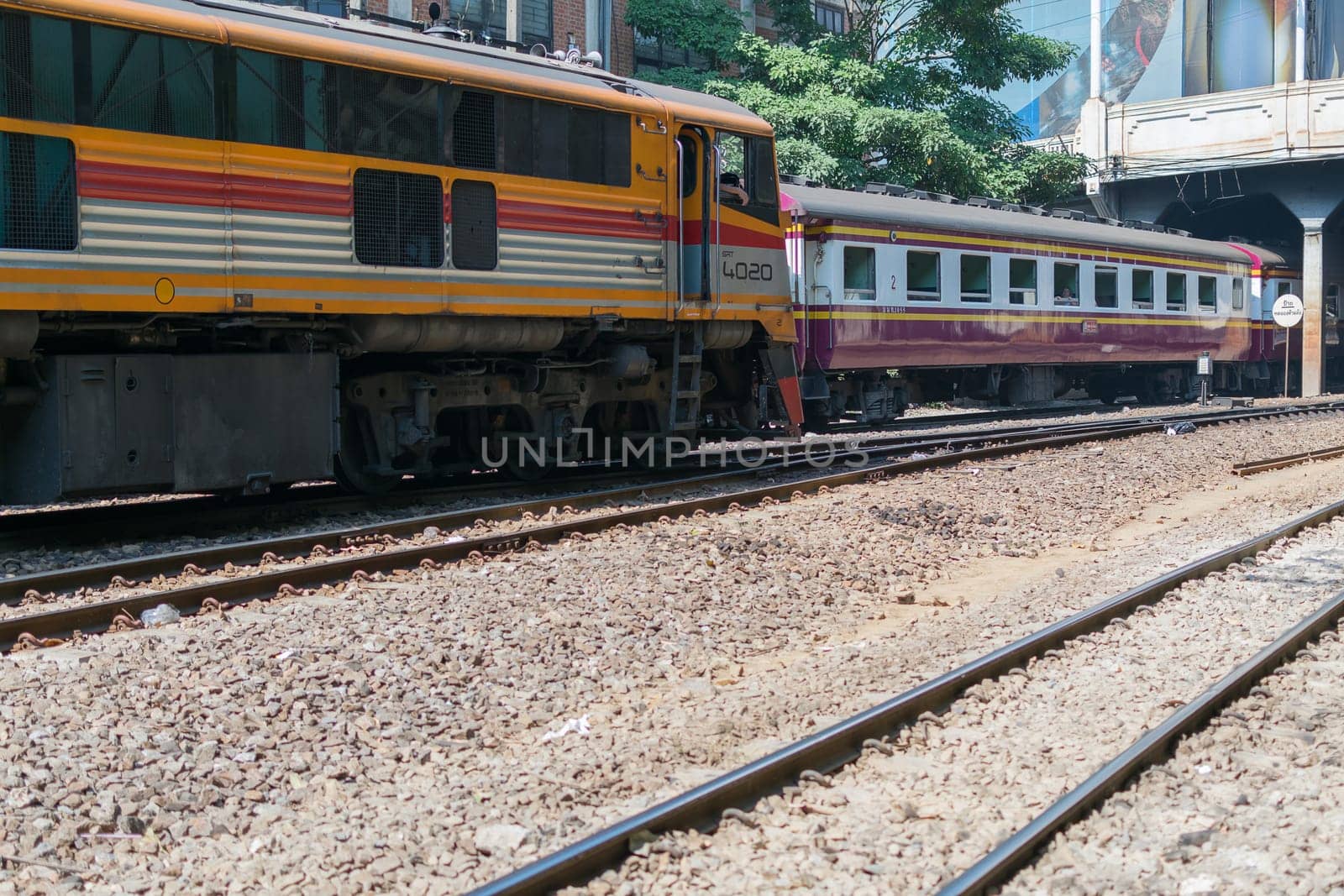 Bangkok, Thailand - December 30, 2015 : Unidentified railway train run on the railroad tracks. Many people in Thailand popular travel by train because it is cheaper.