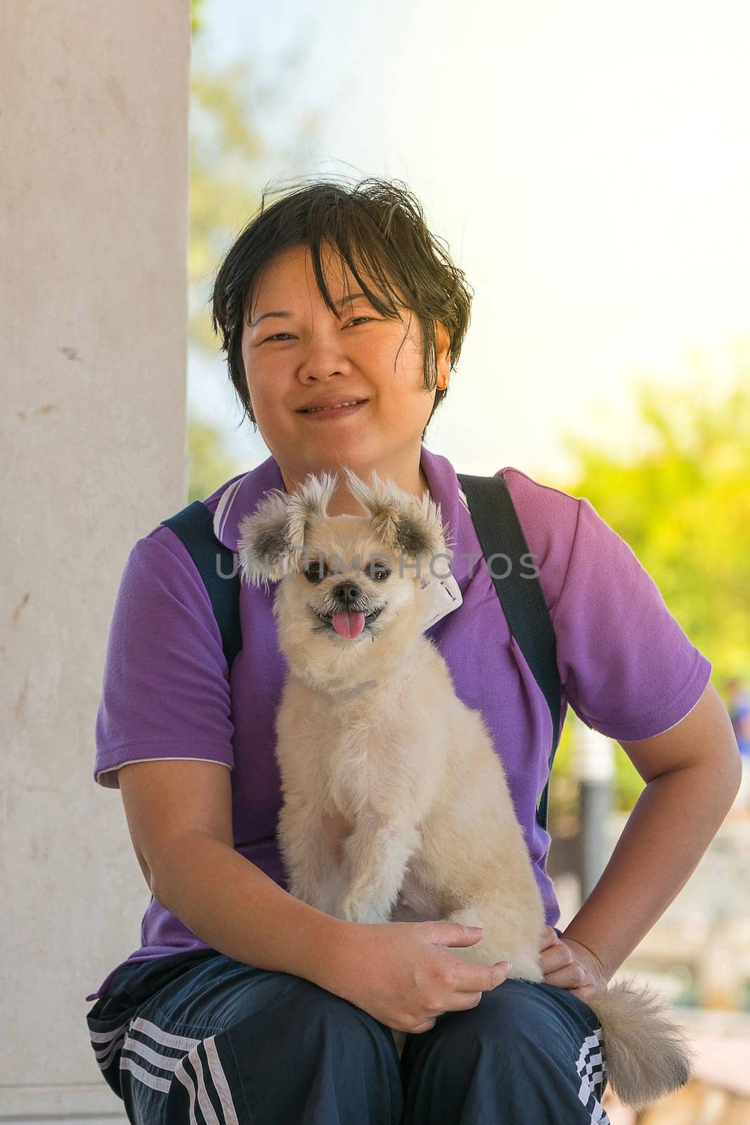 Asia woman plump body and her dog at estuary (river side and sea) when travel , process in soft orange sun light style