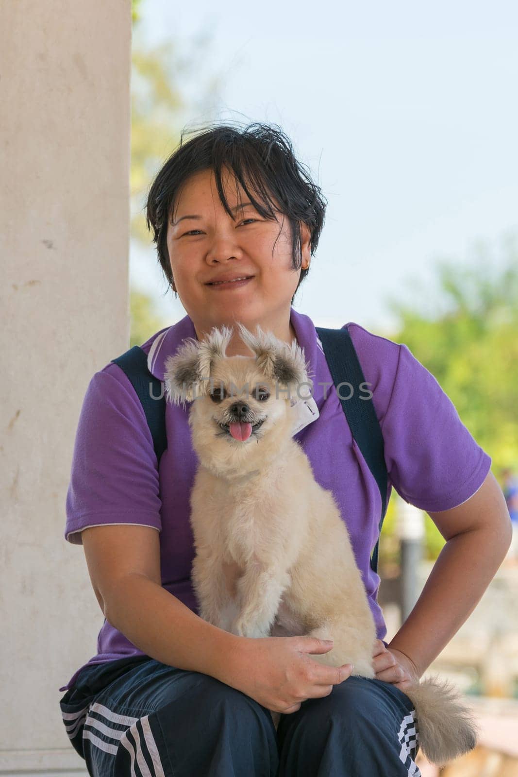 Asia woman plump body and her dog at estuary (river side and sea) when travel
