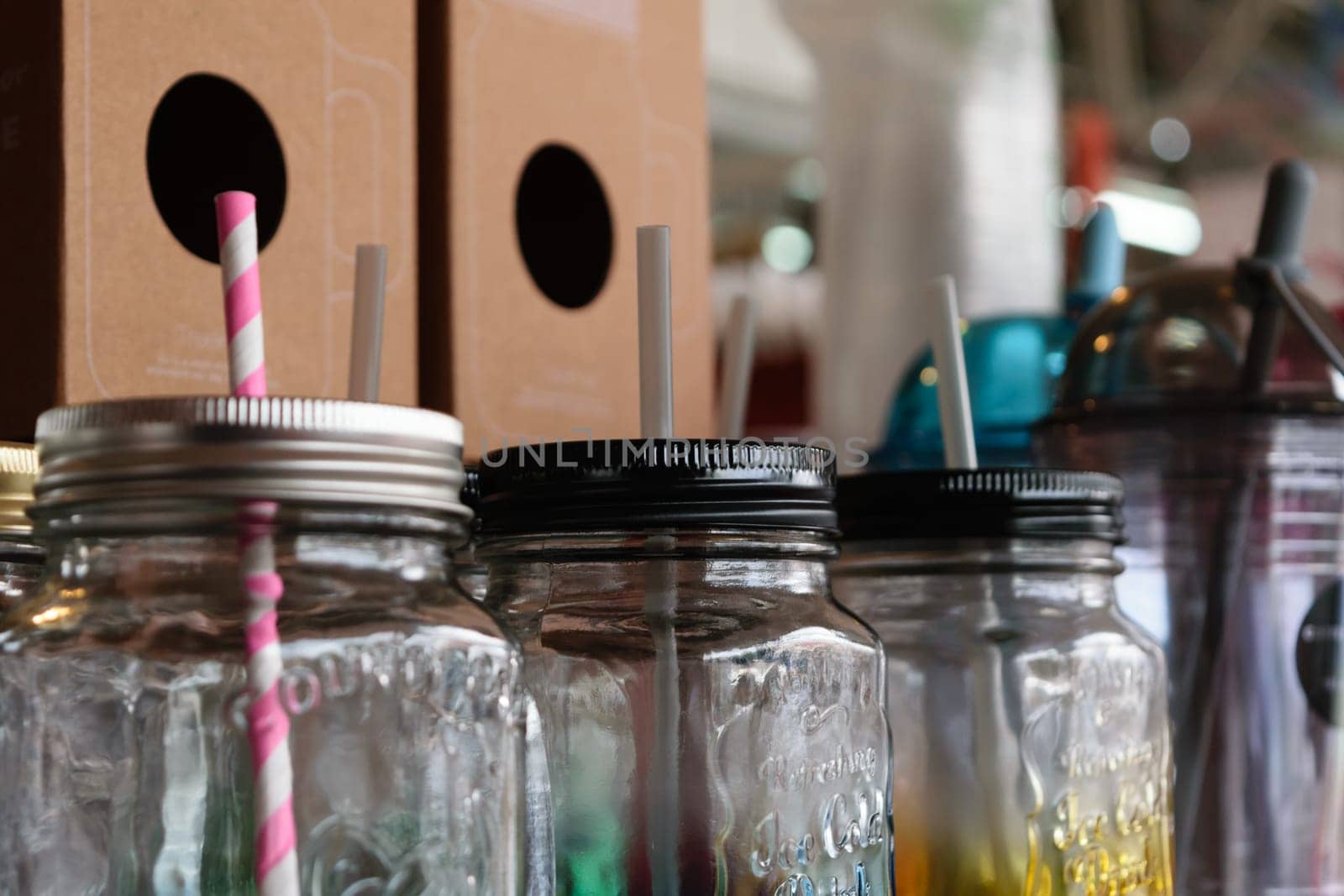 Colorful empty jar with straw