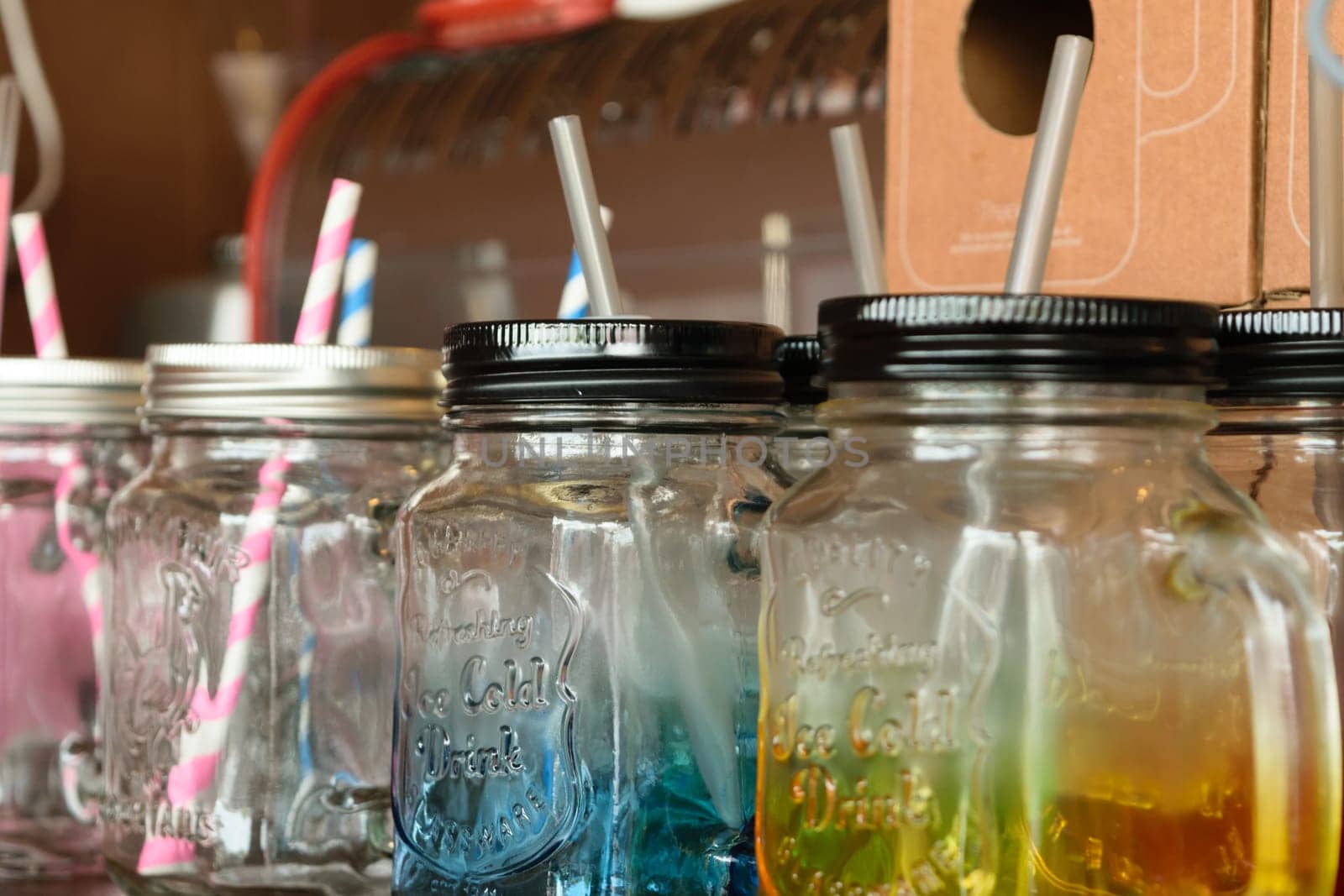 Colorful empty jar with straw