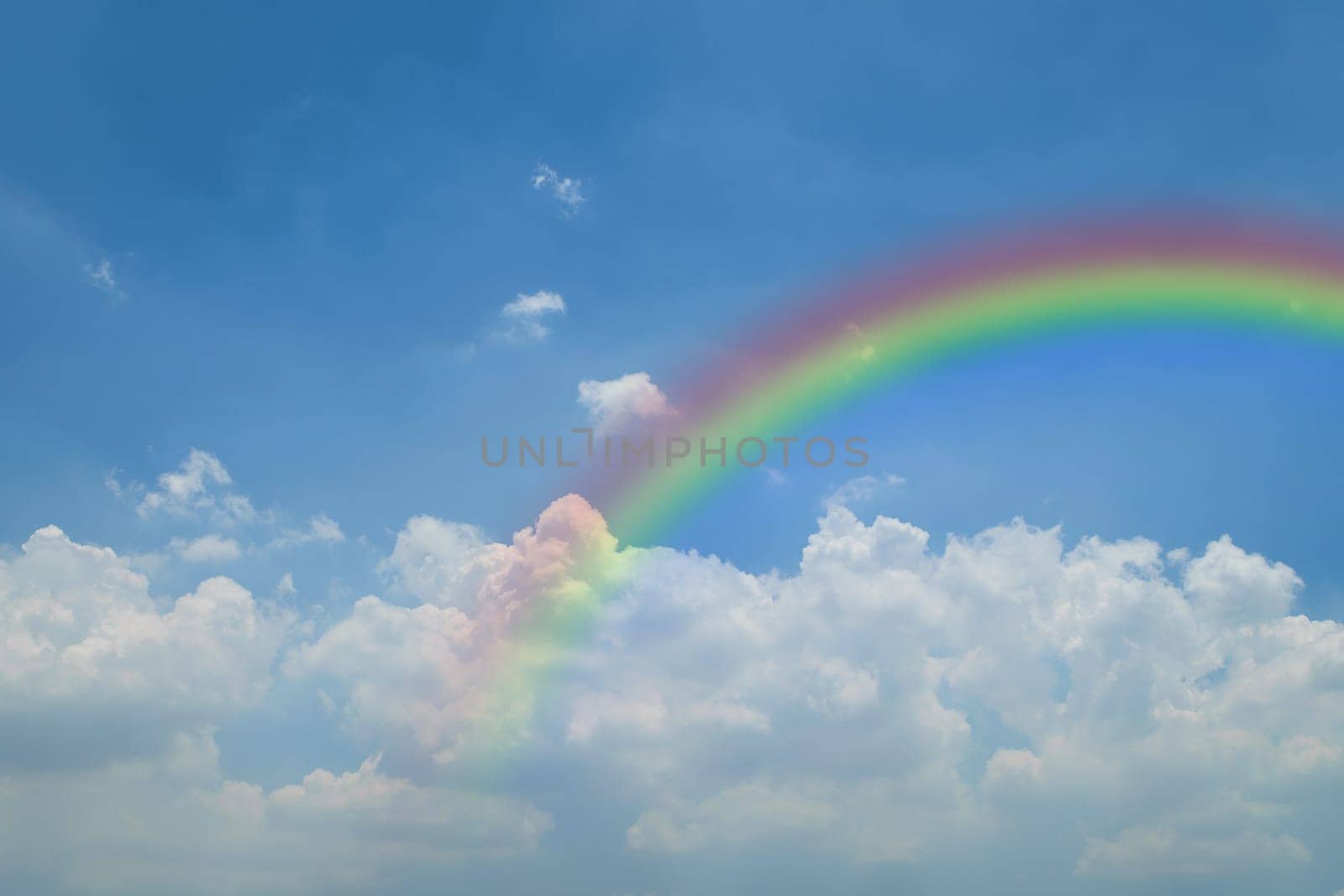 Nature cloudscape with blue sky and white cloud with rainbow
