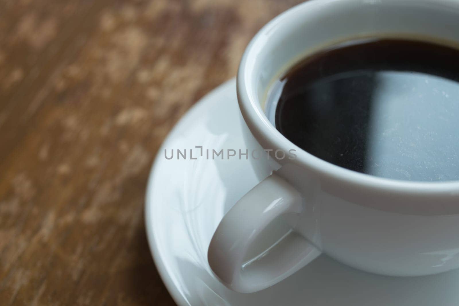 Coffee in white cup on wood table