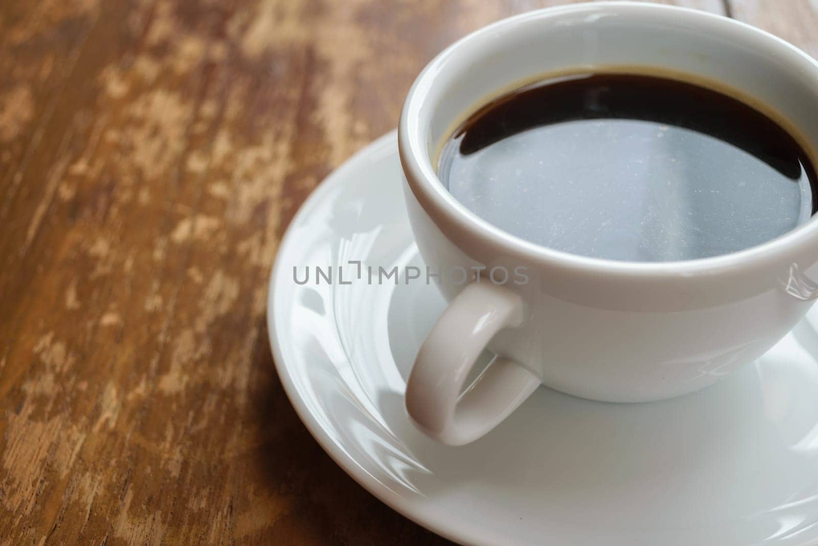 Coffee in white cup on wood table