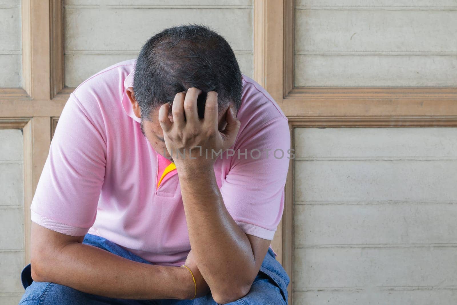 Anxious asian man feeling sadness and stress sitting on the chair