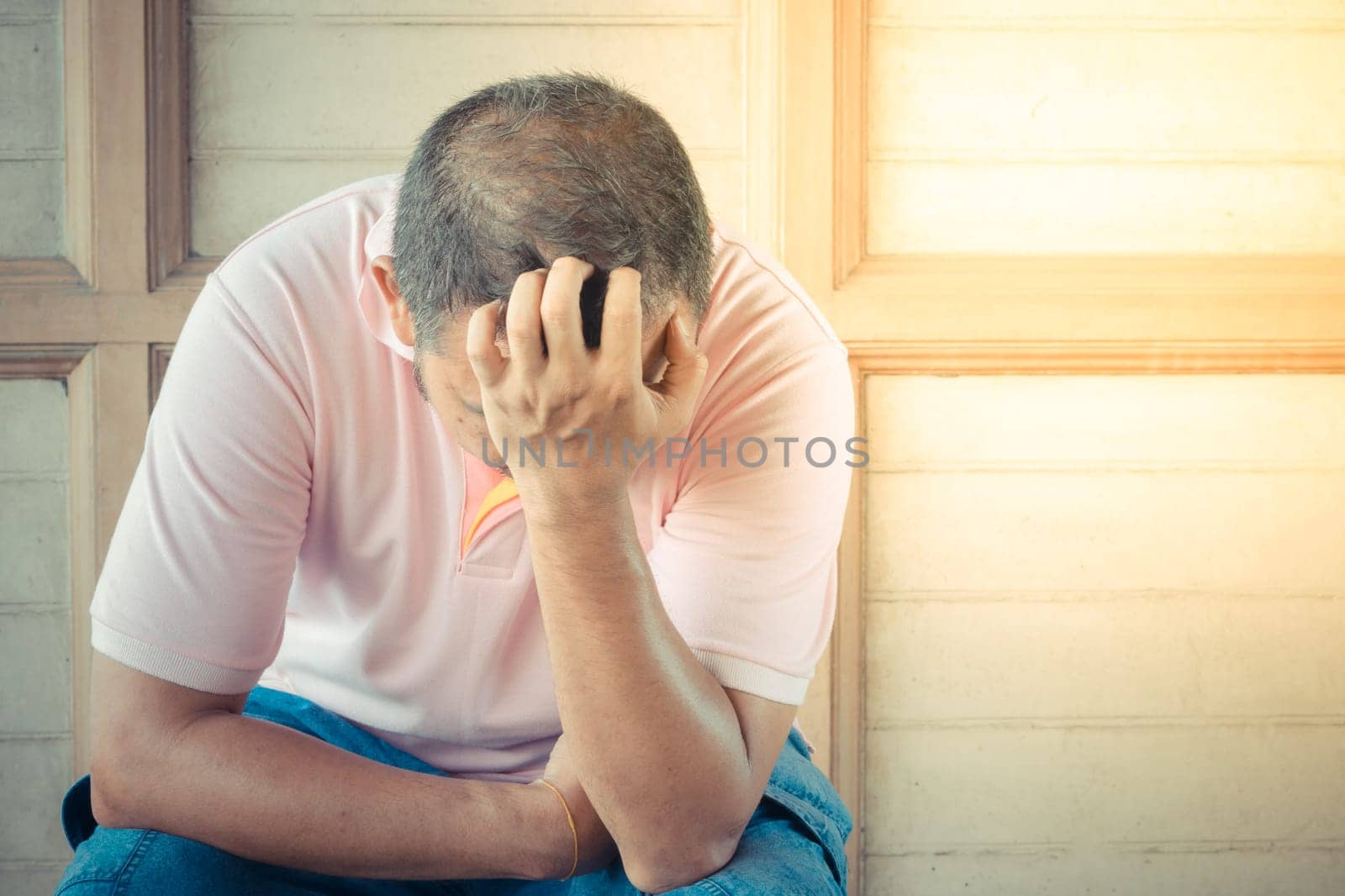 Anxious asian man feeling sadness and stress sitting on the chair , process in vintage style