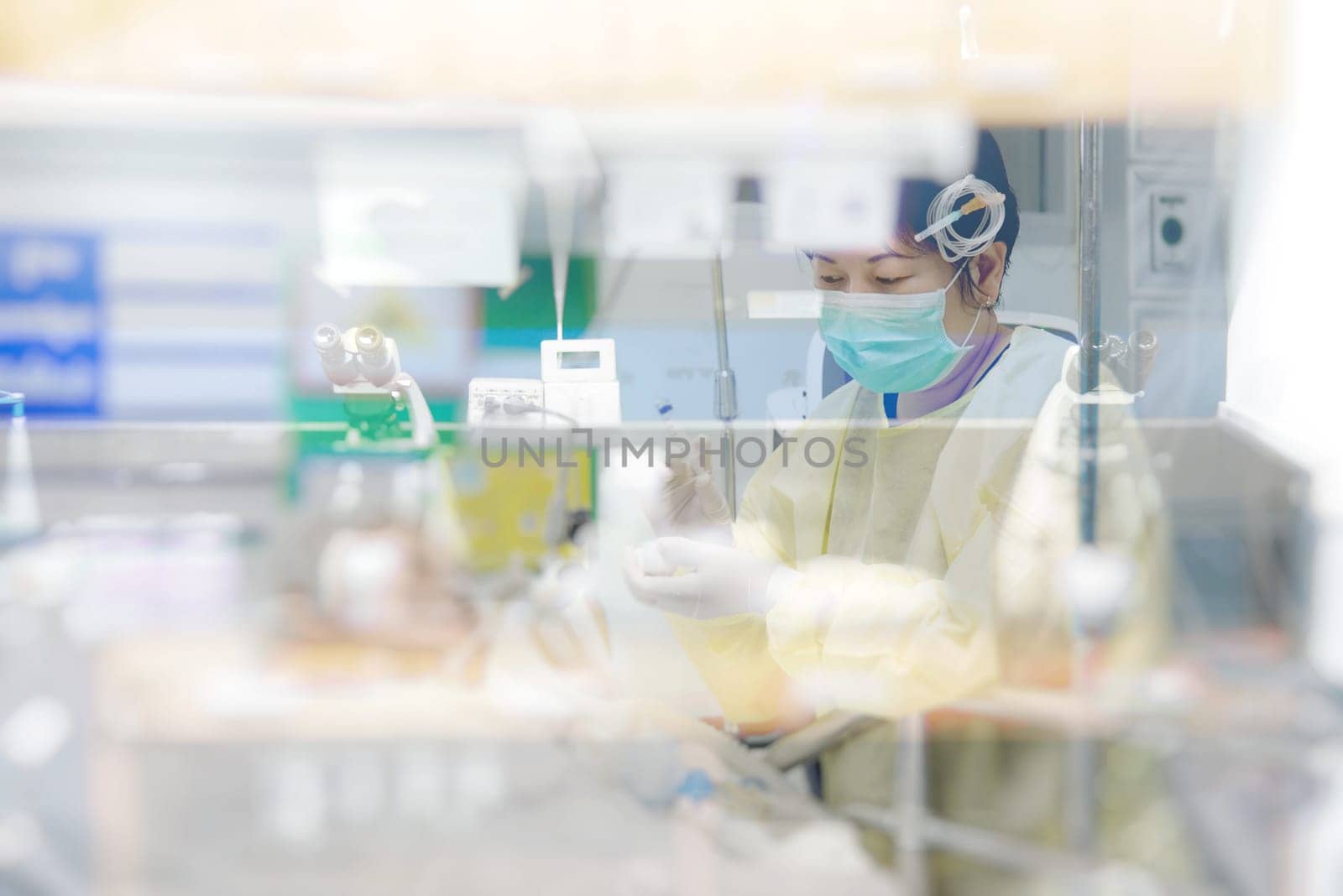 Asian women 40s years old in gown coat is a patient relative taking care of the CRE. or VRE. infected elder patient 80s years old on bed in the hospital.