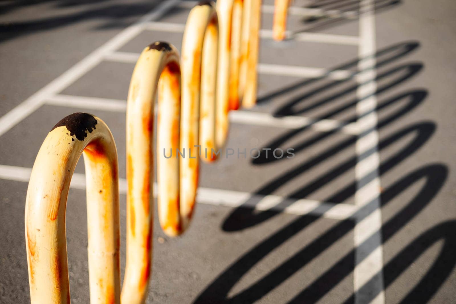 Empty parking space for bicycles in front of the park. Empty bicycle parking lot on the street.