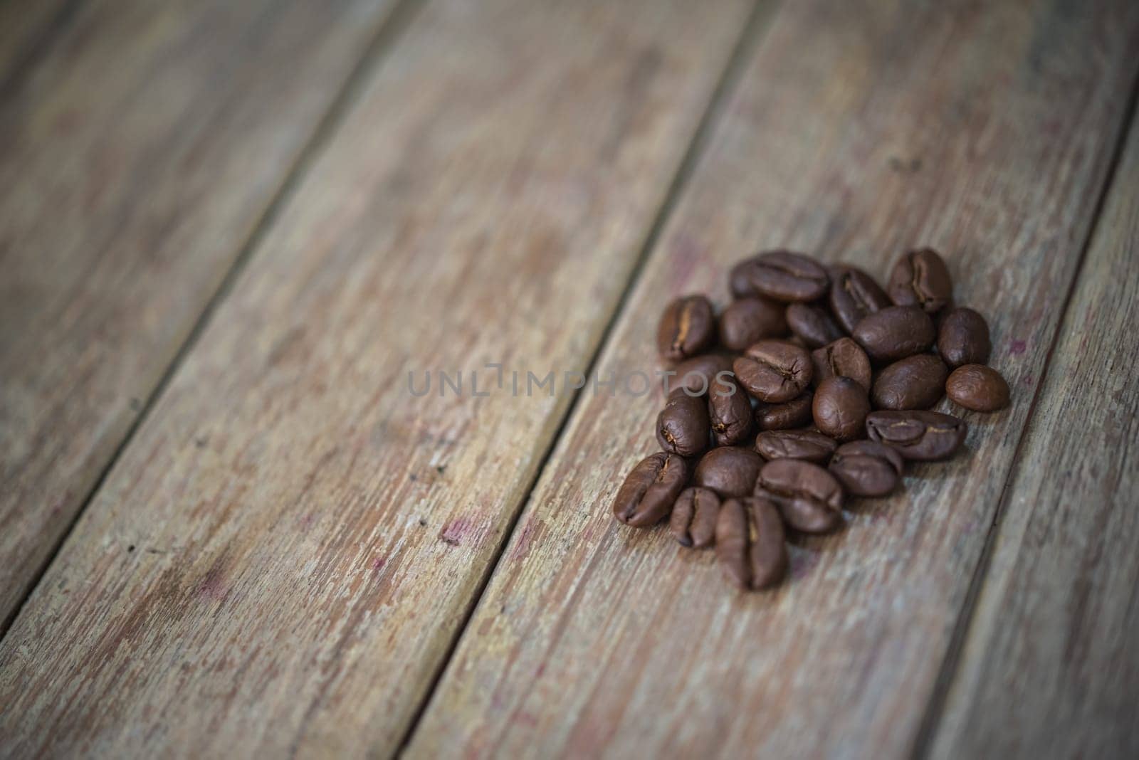 Coffee beans and roasted coffee beans on wooden table in a cafe or coffee shop, traditional vintage style concept