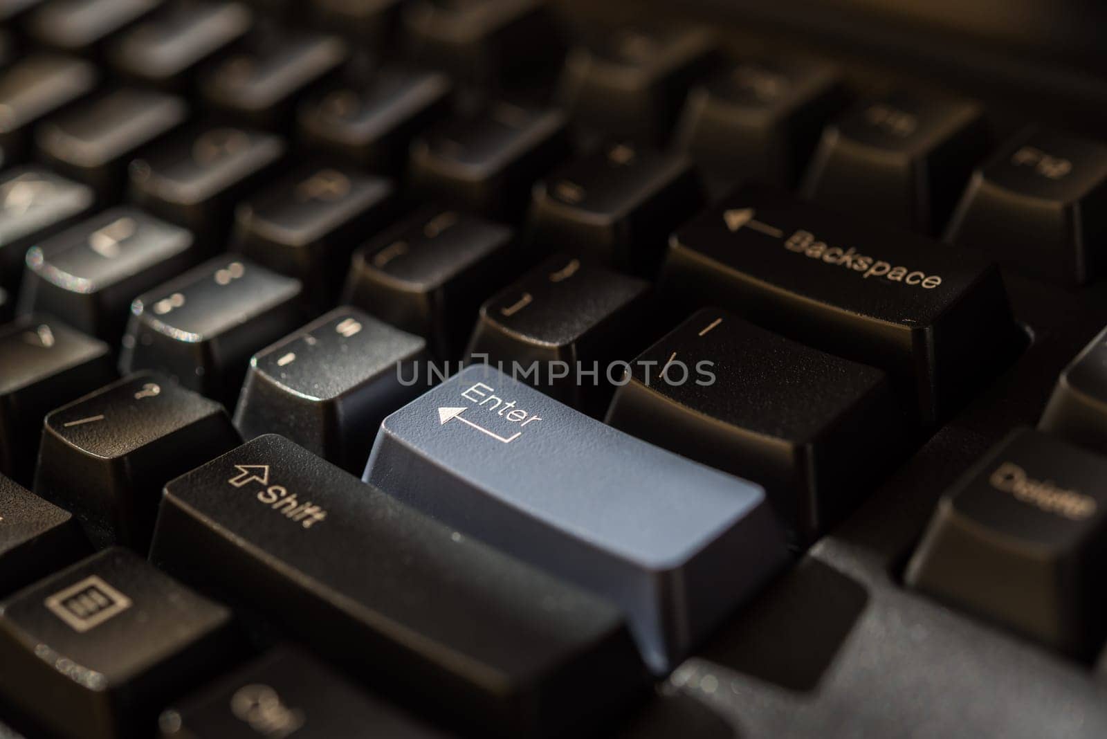 Keyboard for computer server or desktop computer focus on enter button on a keyboard in office, business and information technology concept