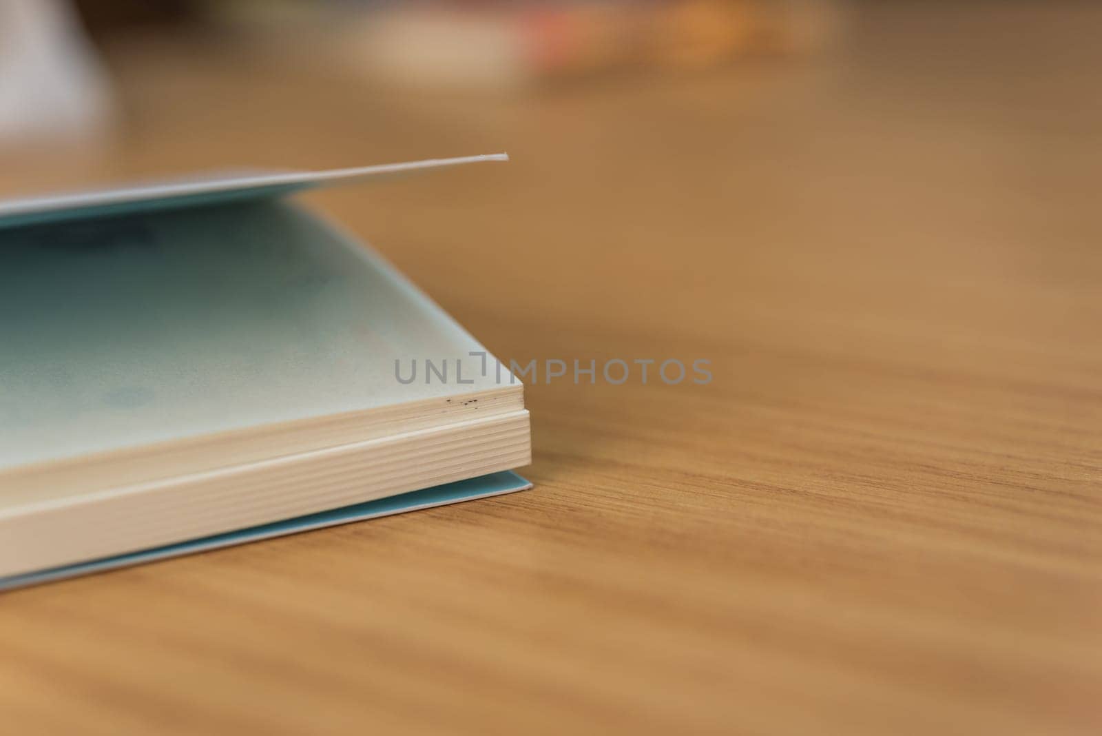 Notebook or note paper sheet in retro style with brown cover and blank white paper on wooden table or desk in business and education concept