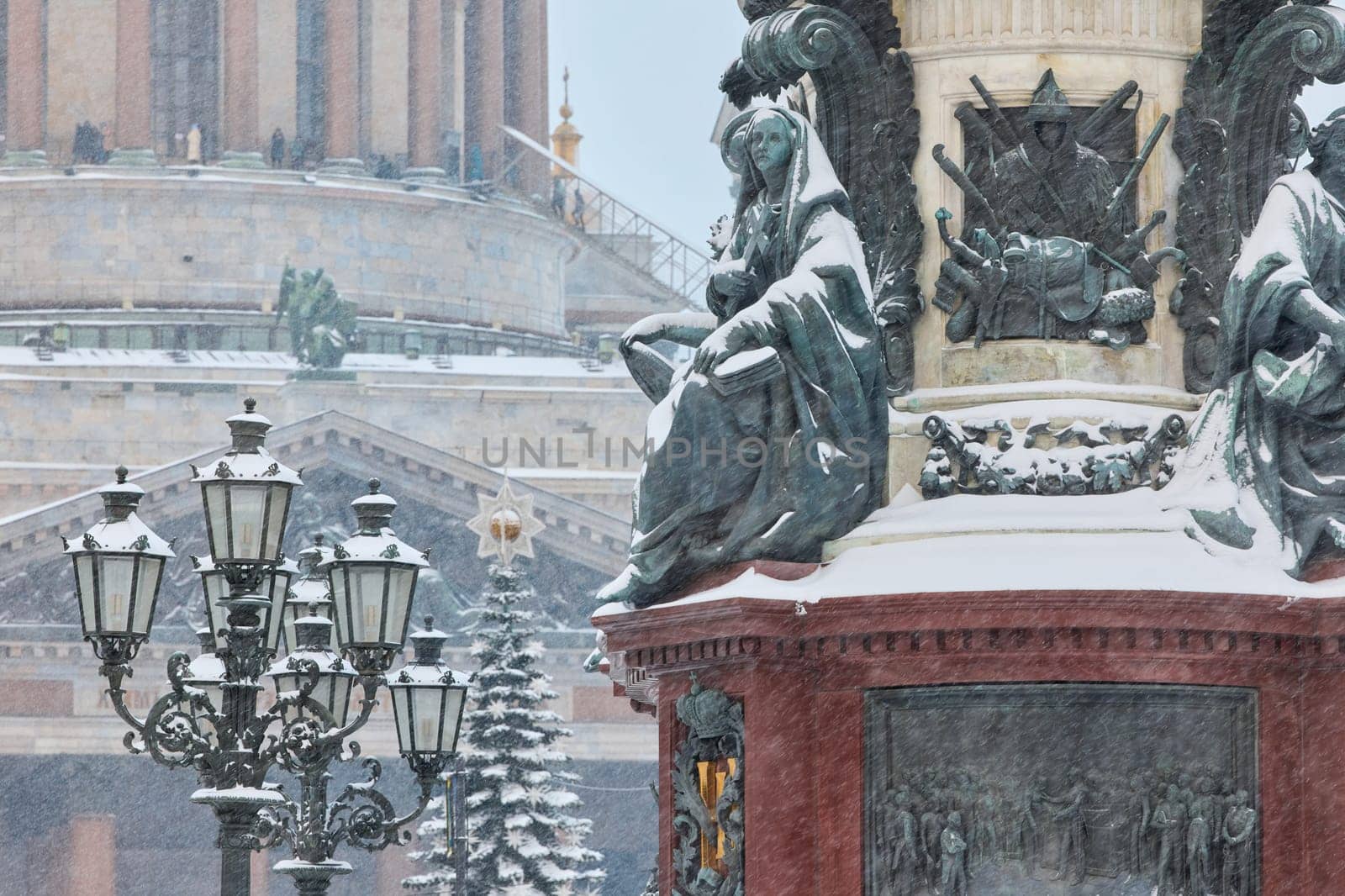 a snow-covered New Year's city decorated for the celebration of the new year, the golden dome of St. Isaac's Cathedral, walking tourists. High quality photo
