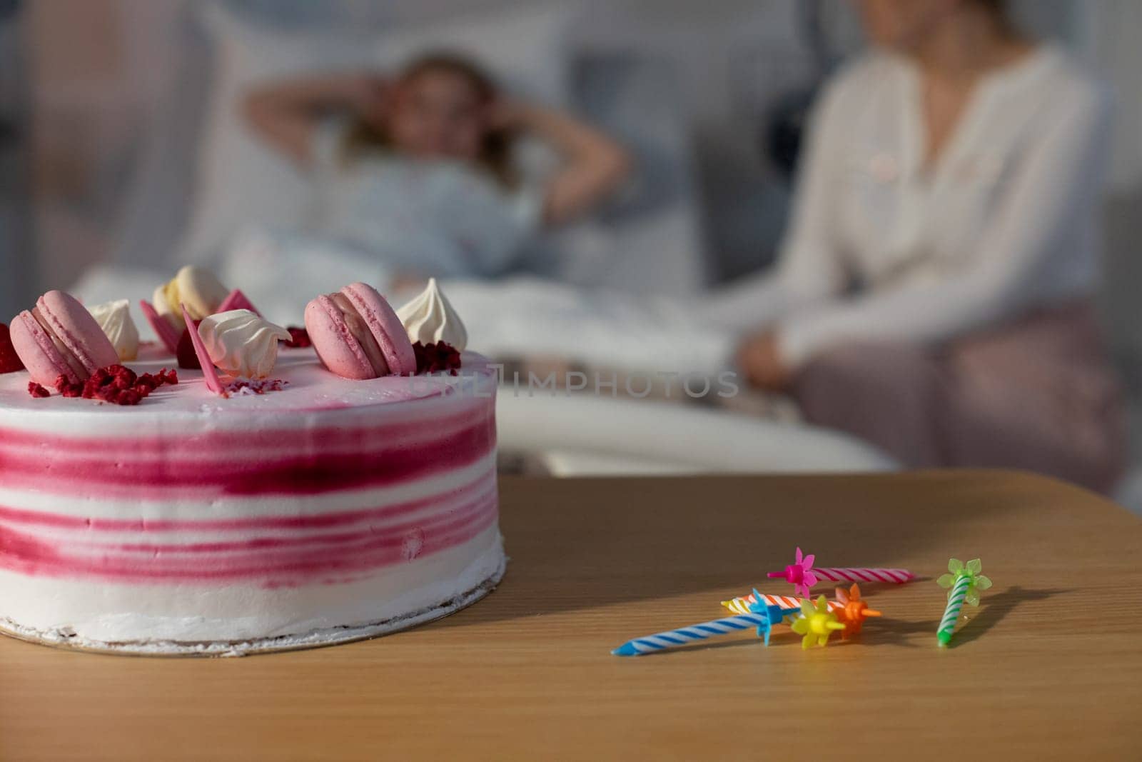 A beautifully colorful cake placed beside a hospital bed, representing both care and celebration in life