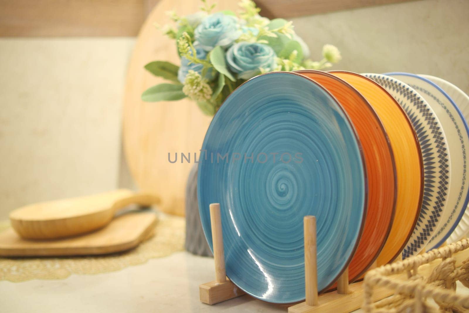 Brightly colored plates arranged neatly on a kitchen counter.