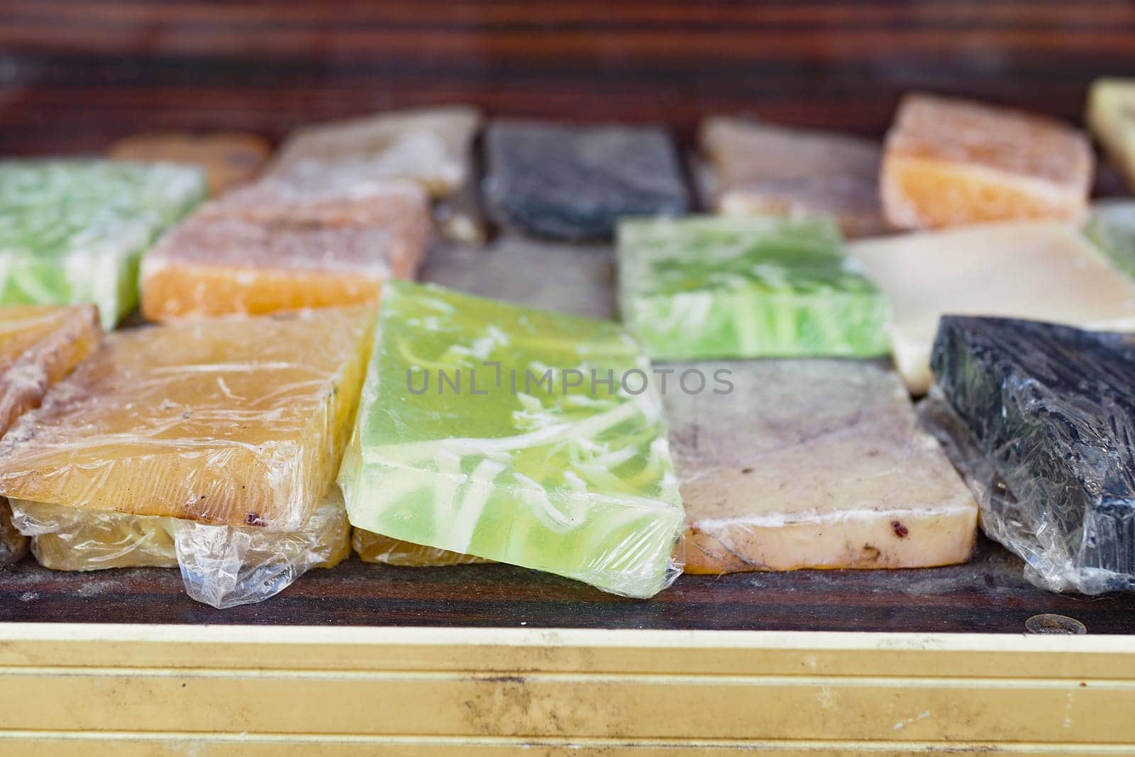 Various handmade soaps in different colors and shapes are on display.