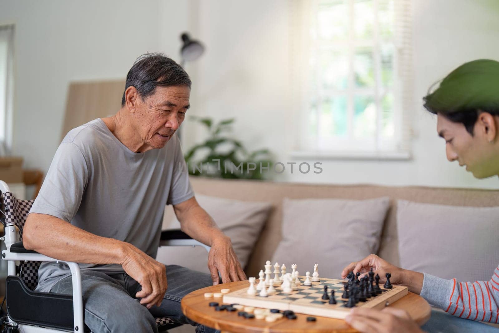 A father and son enjoy a focused chess match, showcasing their connection and the joy of spending quality time together at home.