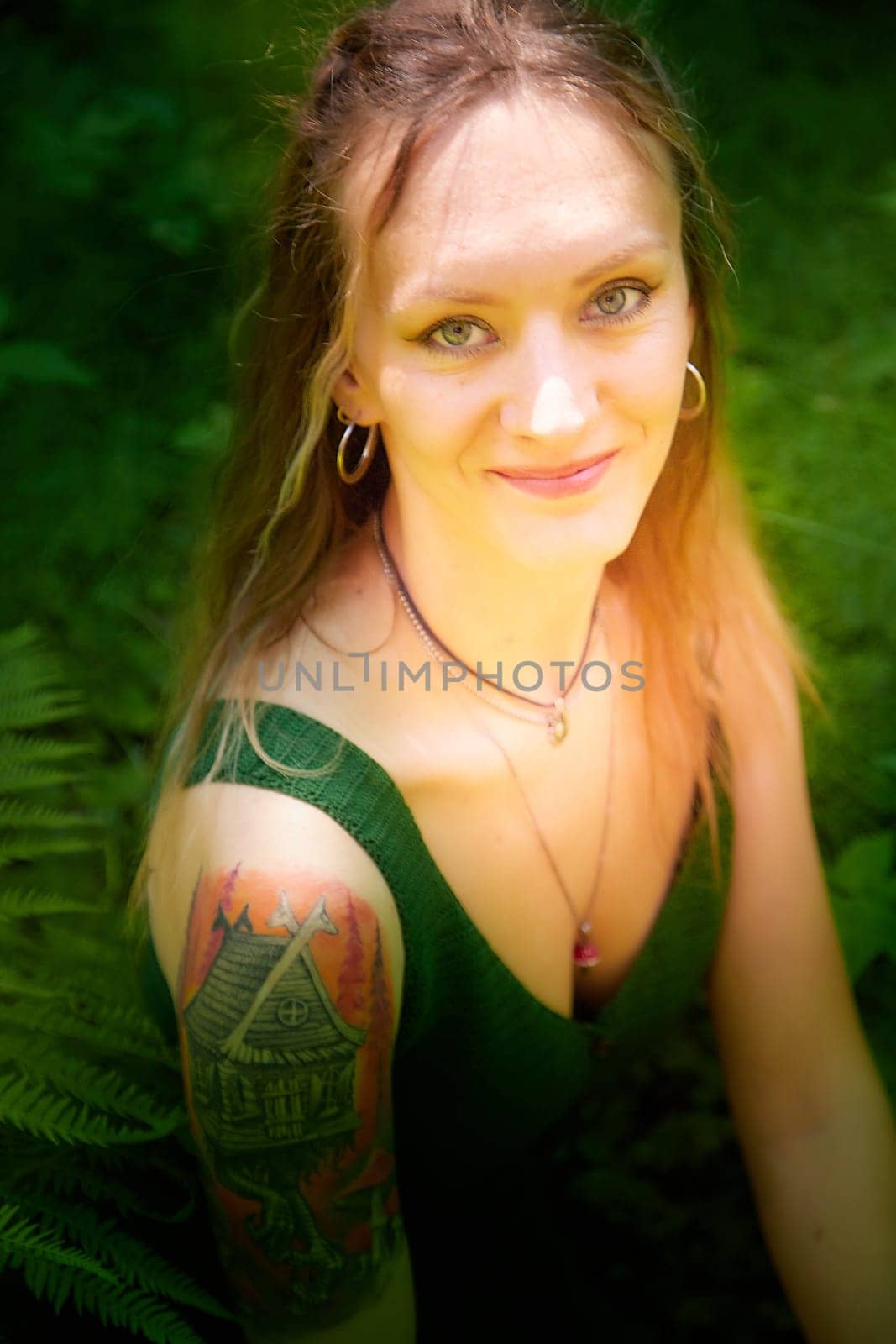Kirov, Russia - June 29, 2022: Portrait of girl looking as peautiful seductive dryad. Pagan spirit of forest. Concept of environmental friendliness and caring for nature
